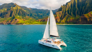 Catamaran sailboat with the dramatic Na Pali coast in the backbround.